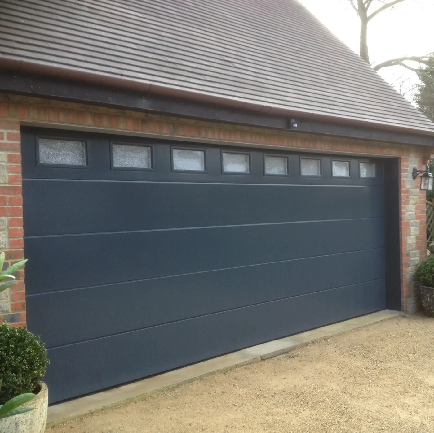 Premium anthracite sectional garage door fitted by Portman Doors